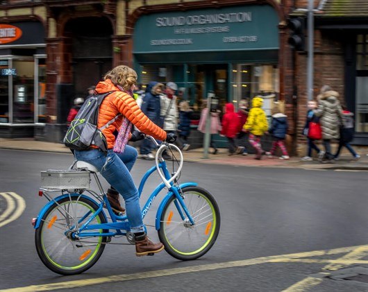 Woman Cyling Across A Junction