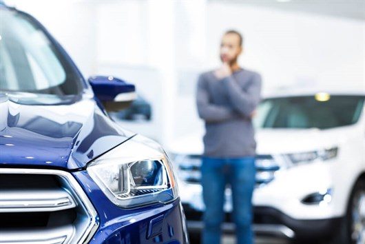 Man In A Car Showroom