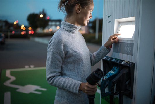Woman Using An EV Charger