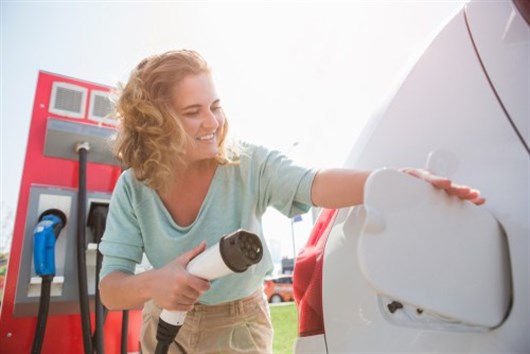 Woman Charging An EV