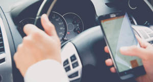 Any hand-held mobile phone use at the wheel now illegal