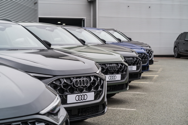 New Audi models lined up outside an Audi dealership